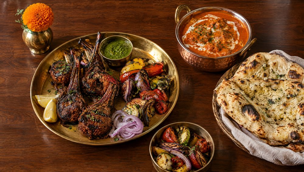 A platter of tandoori lamb chops, butter chicken and naan